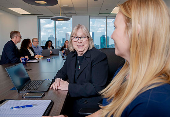 CSG consultants talking at a conference table