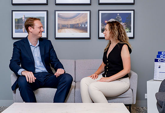 Two coworkers talking in office lobby