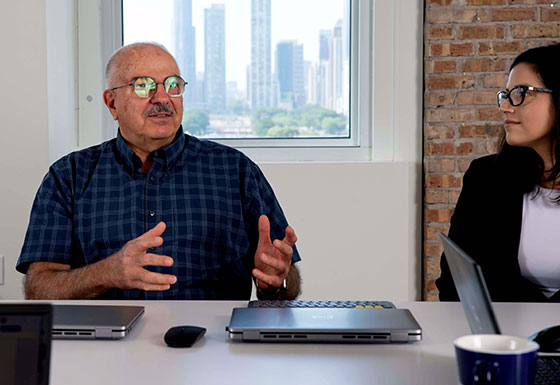 Two CSG employees in deep discussion at conference table